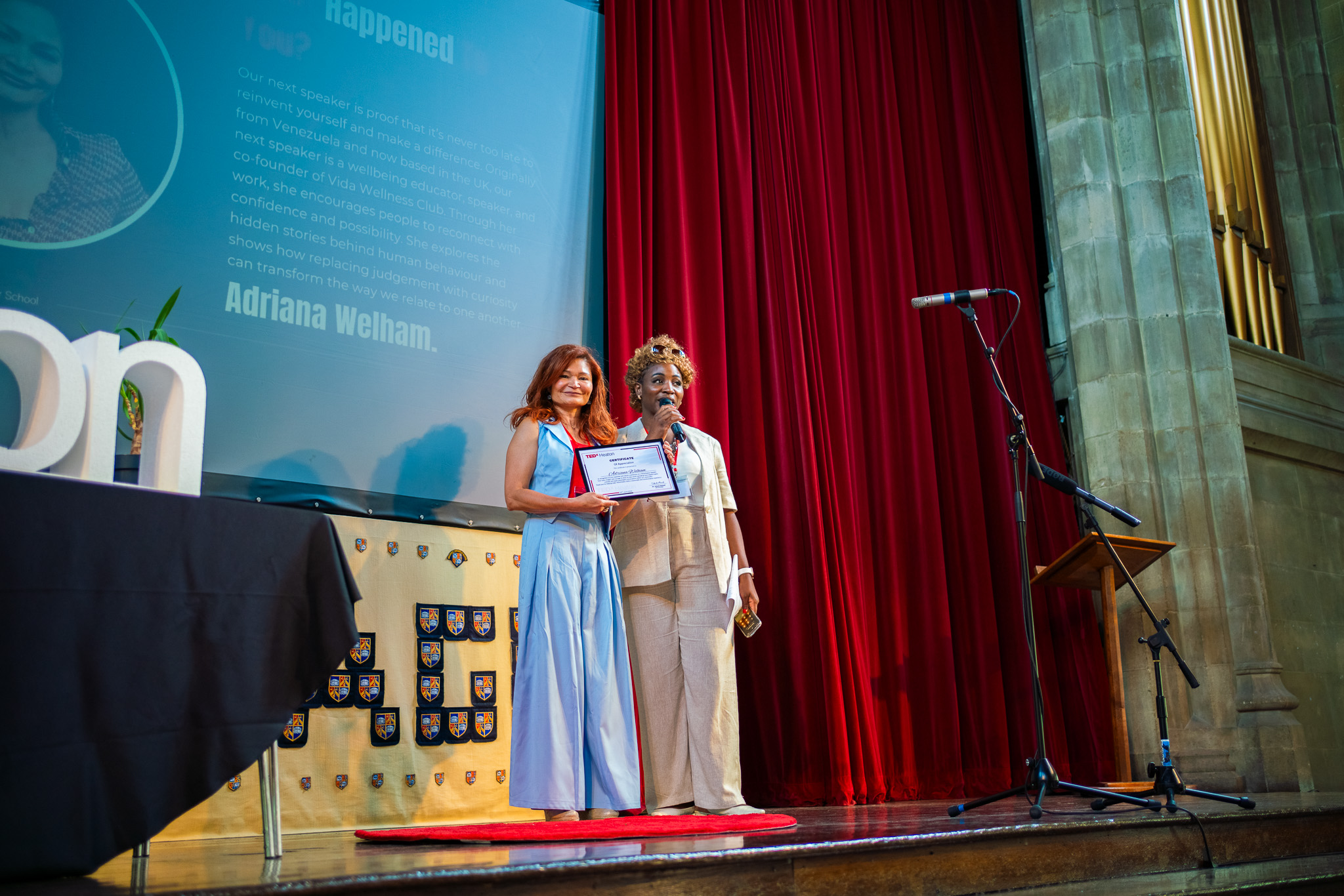 Adriana Welham receiving her TEDxHeaton Certificate of Appreciation on stage